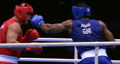 Image: Anthony Joshua knocks down Zhieli Zhang on his way to a very comfortable win